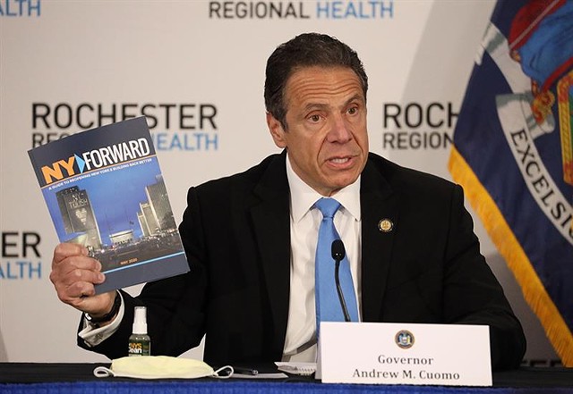 Governor Andrew Cuomo displays a copy of NY Forward, his plan to reopen the state in phases. On Monday, May 11, Cuomo held his daily COVID-19 briefing at Rochester Regional Health’s Riedman Campus Training Center in Irondequoit. - PHOTO BY MAX SCHULTE