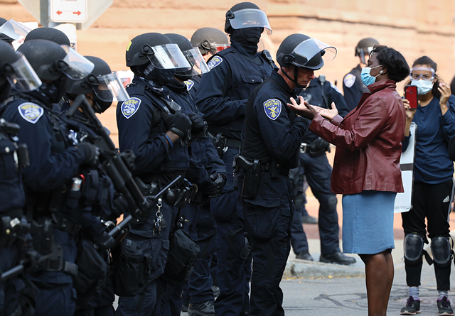 The Rev. Myra Brown confronts Rochester police officers to broker a peaceful resolution to their standoff with Black Lives Matter protestors on Sept. 16, 2020. - PHOTO BY MAX SCHULTE