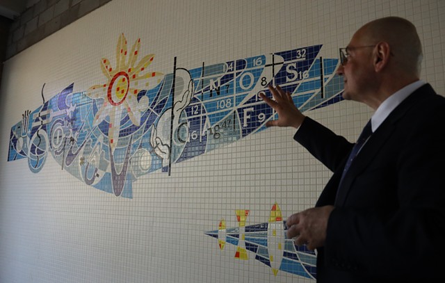 Delta-X CEO Derek Dlugosh-Ostap remarks on the craftsmanship of a mosaic that was unearthed at a former Kodak research building he is rehabilitating. He said he plans to preserve the mural. - PHOTO BY MAX SCHULTE