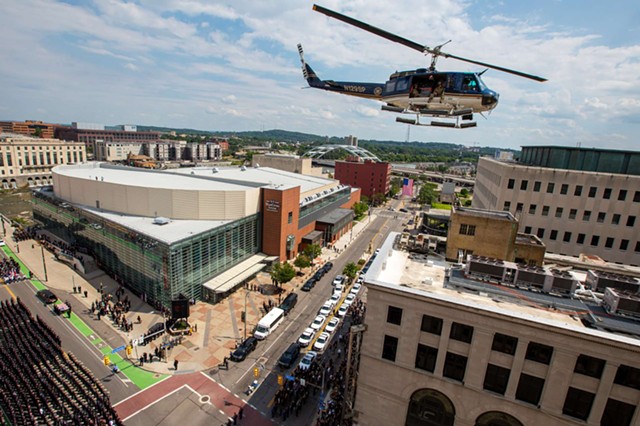 A police helicopter flies over the funeral procession for slain police officer, Anthony Mazurkiewicz, in downtown Rochester on Aug. 1, 2022. - PHOTO BY LAUREN PETRACCA