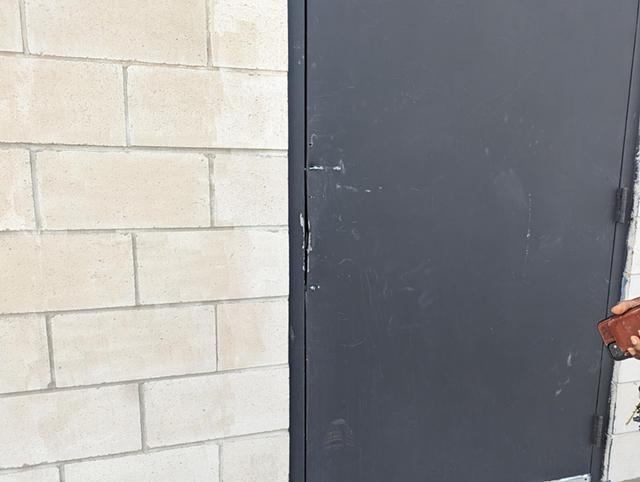 The rear door of The Avenue Blackbox Theatre was bolted shut following the execution of a search warrant April 19, 2023. - PHOTO BY GINO FANELLI