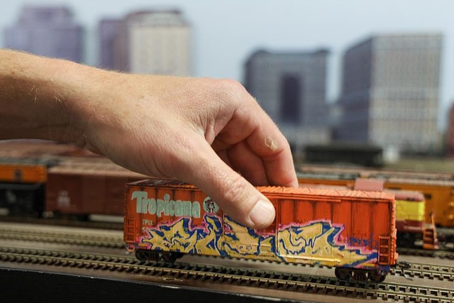 Tropicana freight cars are coveted by model railroaders. Alex Price tries to make them look like they do in real life. - PHOTO BY MAX SCHULTE
