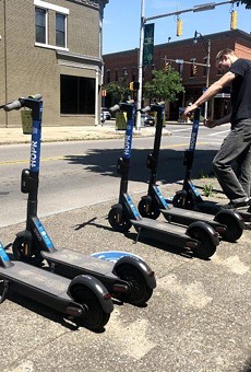 A worker lines up some of the electric scooters that HOPR uses in its bike and scooter share program.